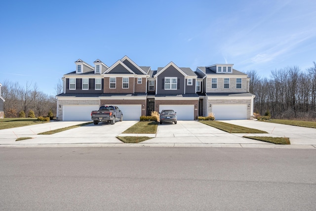 townhome / multi-family property featuring driveway and a garage