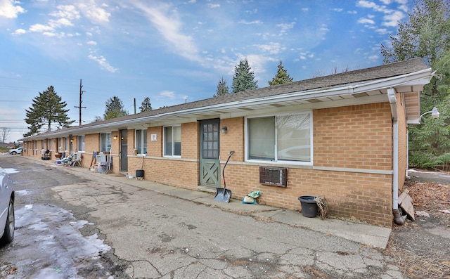 single story home featuring brick siding