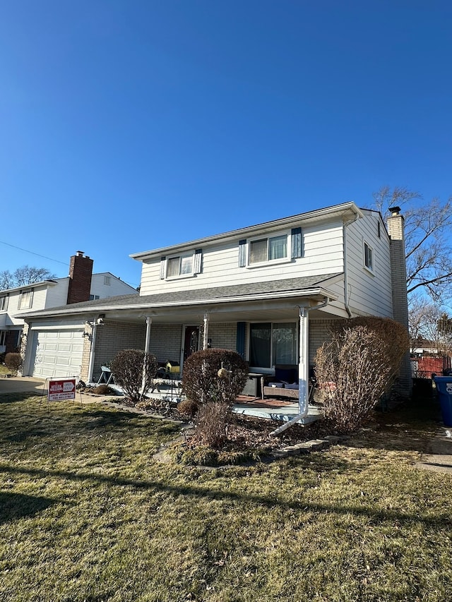 view of front of home with a front lawn, brick siding, a garage, and a chimney