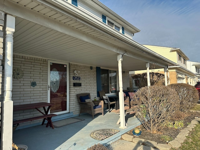 view of patio / terrace featuring covered porch and a garage