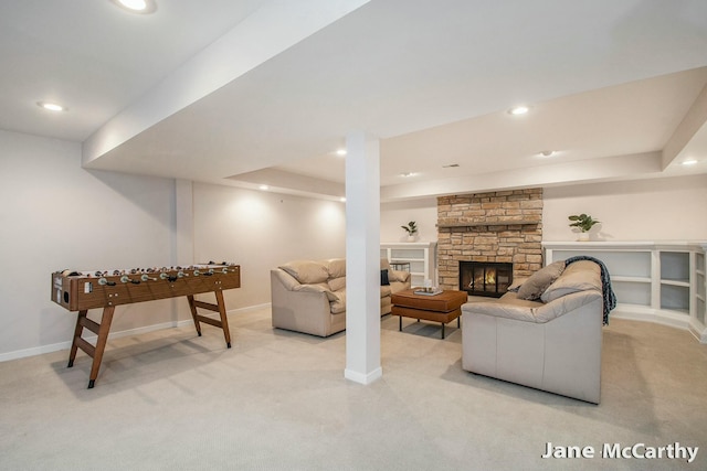 living room featuring recessed lighting, a fireplace, baseboards, and light carpet