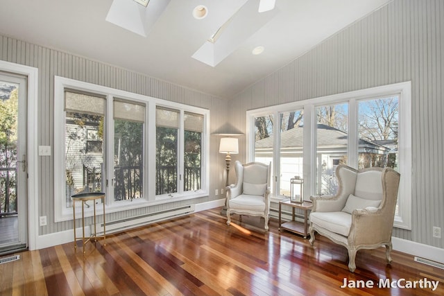 sitting room with visible vents, wallpapered walls, wood-type flooring, lofted ceiling with skylight, and baseboard heating