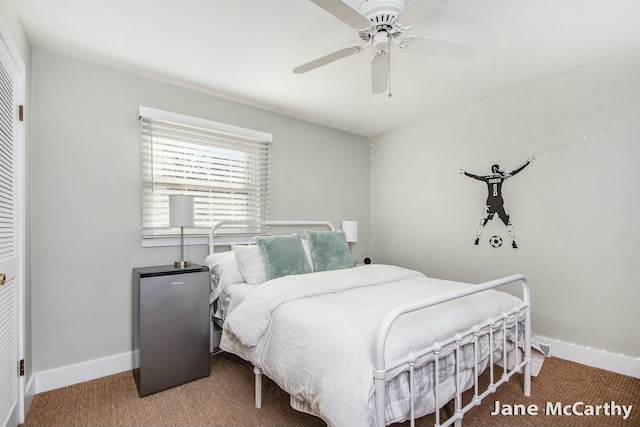 carpeted bedroom featuring baseboards, a closet, and ceiling fan