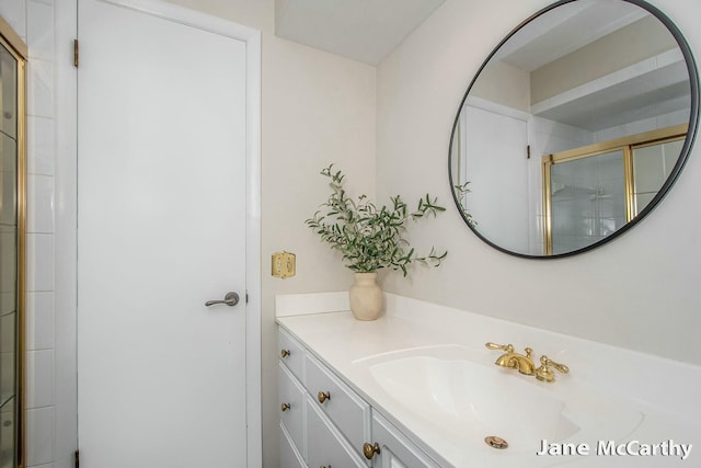 full bath with a shower with shower door and vanity