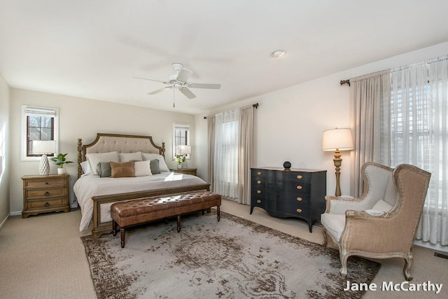 bedroom with visible vents, multiple windows, ceiling fan, and carpet flooring