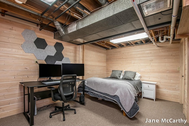 carpeted bedroom featuring wood walls