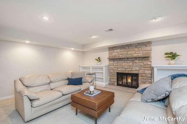 living room featuring a stone fireplace, recessed lighting, visible vents, and carpet floors