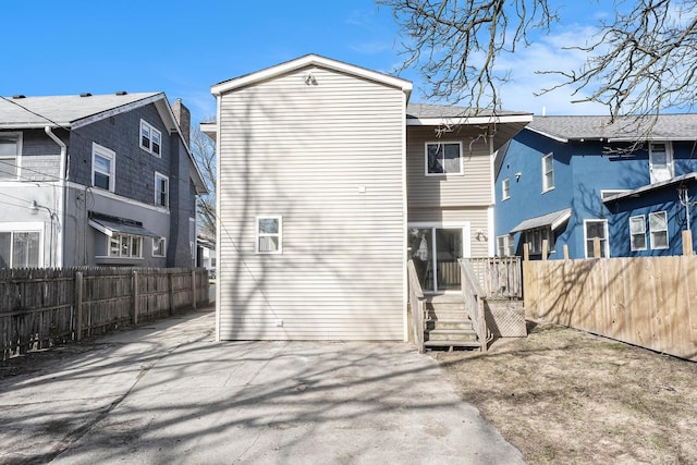 rear view of house with a fenced backyard and a patio area