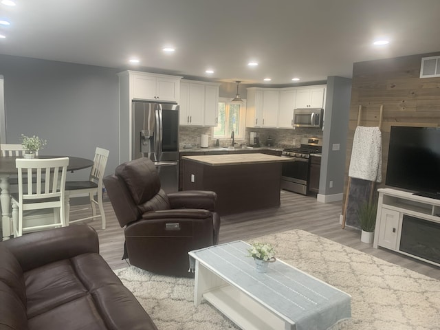 living area featuring visible vents, recessed lighting, and light wood-type flooring