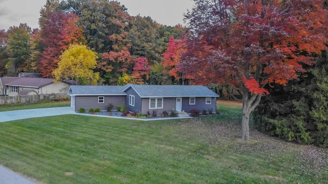 ranch-style house with a front lawn, fence, and driveway