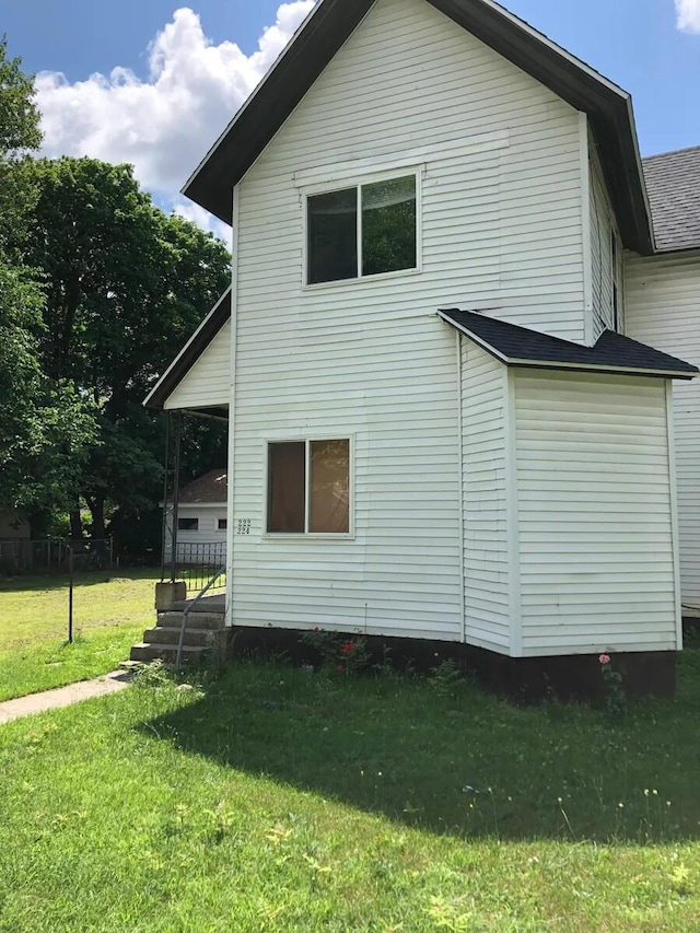 view of side of home with a lawn