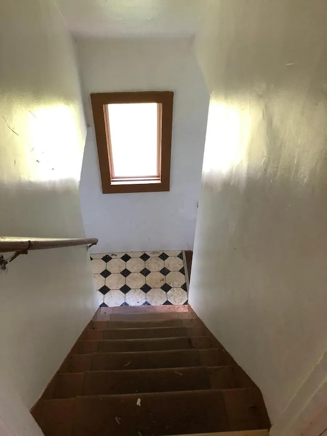 stairs featuring tile patterned floors