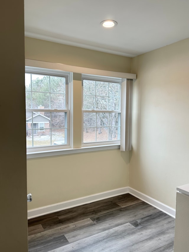 unfurnished room featuring recessed lighting, baseboards, and dark wood finished floors