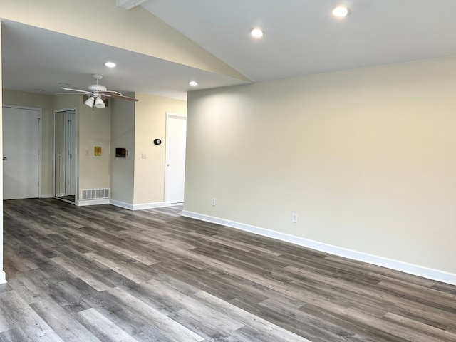 unfurnished room with visible vents, dark wood-type flooring, baseboards, vaulted ceiling, and recessed lighting