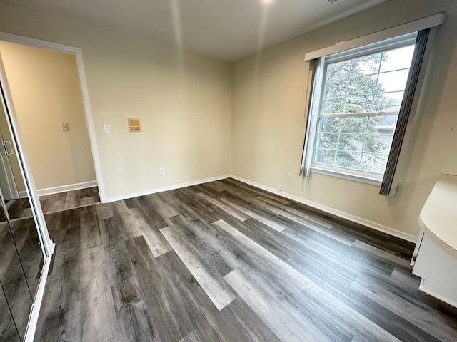 interior space with dark wood-style floors and baseboards