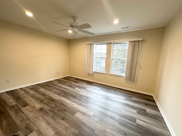 spare room with visible vents, ceiling fan, baseboards, recessed lighting, and dark wood-style flooring