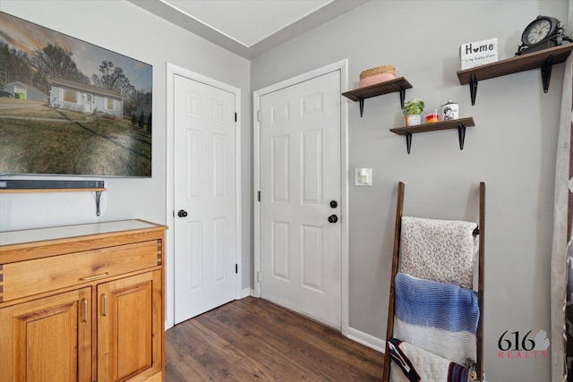 interior space with baseboards and dark wood-style flooring