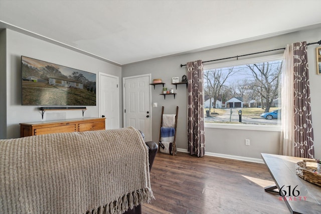 bedroom featuring wood finished floors and baseboards