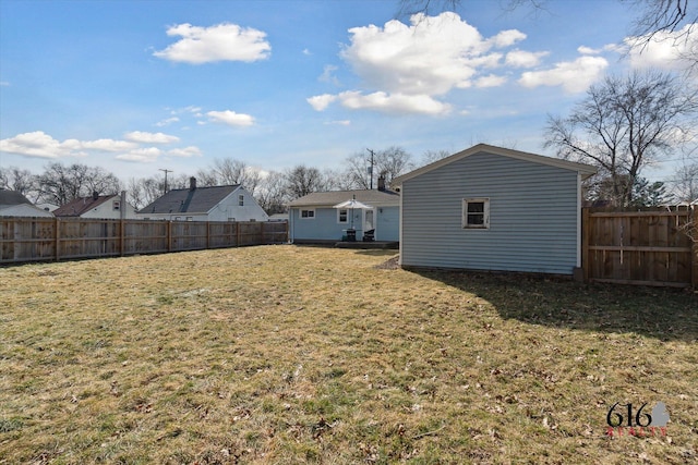 view of yard featuring an outbuilding and a fenced backyard