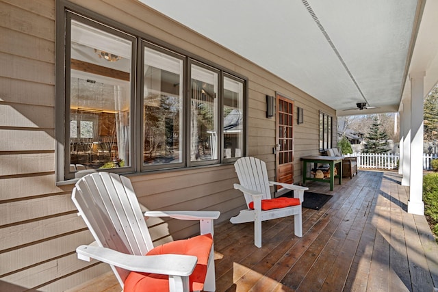 wooden deck with a porch and ceiling fan