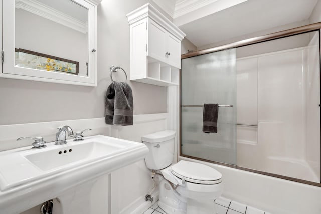 bathroom featuring toilet, ornamental molding, shower / bath combination with glass door, tile patterned floors, and a sink