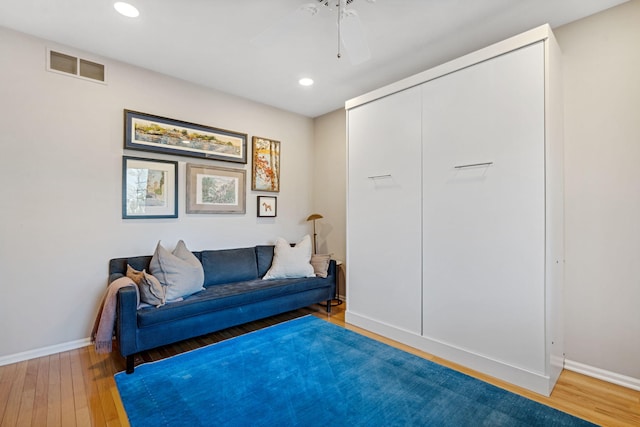 sitting room with recessed lighting, visible vents, wood-type flooring, and baseboards