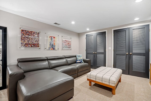 living area featuring recessed lighting, visible vents, french doors, and light carpet