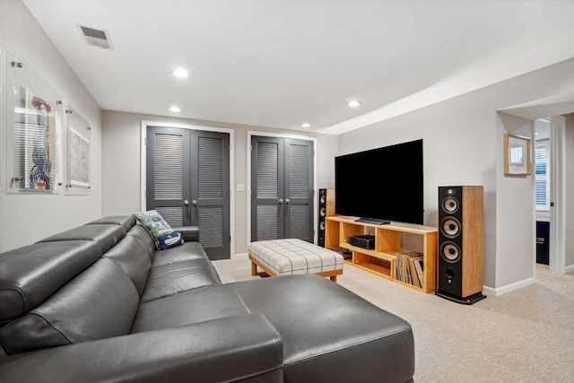 living room featuring light carpet, visible vents, recessed lighting, and baseboards