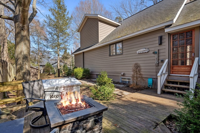 wooden terrace featuring an outdoor fire pit and entry steps