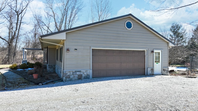 view of home's exterior featuring a trampoline and driveway