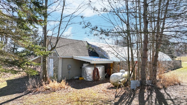 view of home's exterior with roof with shingles