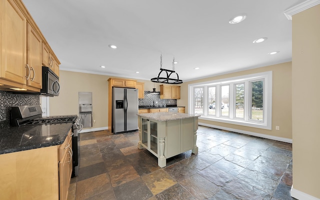 kitchen featuring stone tile flooring, crown molding, baseboards, and stainless steel appliances