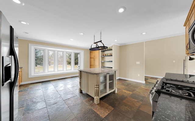 kitchen with stone tile floors, recessed lighting, appliances with stainless steel finishes, crown molding, and baseboards