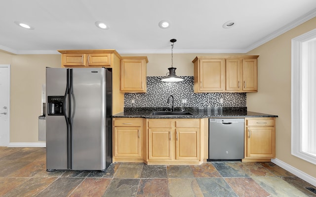 kitchen with a sink, appliances with stainless steel finishes, light brown cabinets, and stone tile floors