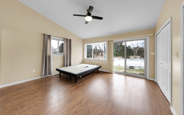 rec room featuring vaulted ceiling, wood finished floors, and baseboards