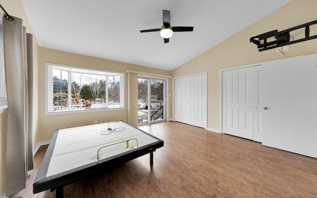 playroom with baseboards, wood finished floors, a ceiling fan, and vaulted ceiling