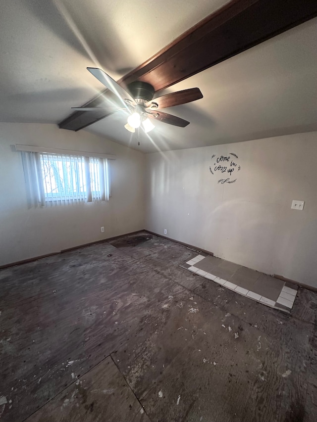 spare room featuring vaulted ceiling with beams and a ceiling fan