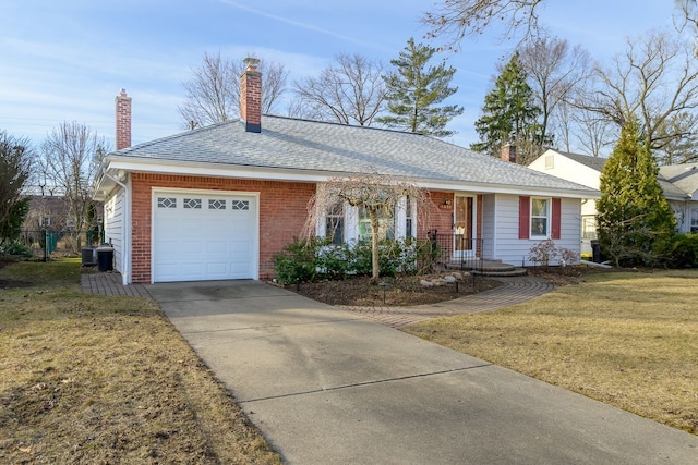 ranch-style home featuring brick siding, a front lawn, concrete driveway, a chimney, and a garage