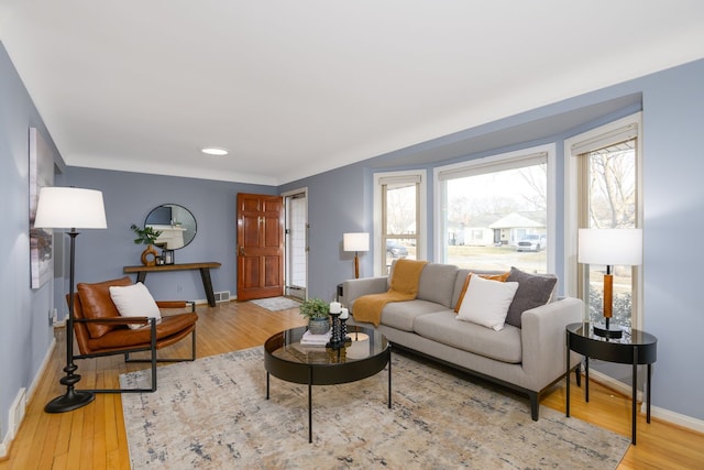 living area featuring baseboards and wood finished floors