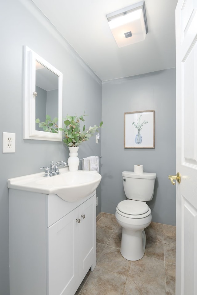 half bath featuring toilet and vanity