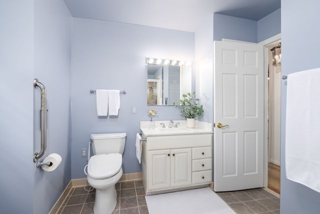 full bath featuring vanity, tile patterned floors, toilet, and baseboards