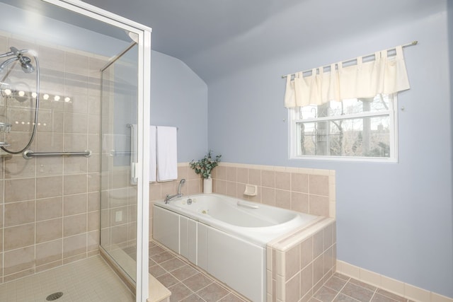 full bathroom with lofted ceiling, a bath, a stall shower, and tile patterned flooring