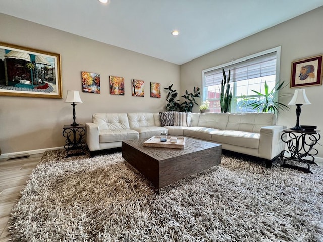 living room featuring recessed lighting, visible vents, baseboards, and wood finished floors