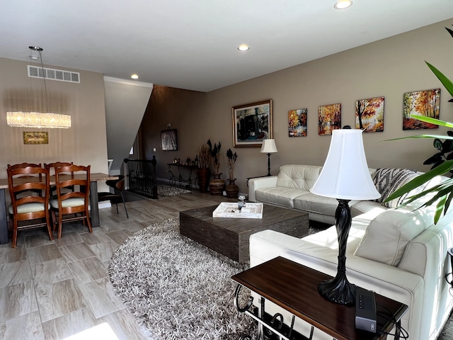 living room featuring visible vents and recessed lighting