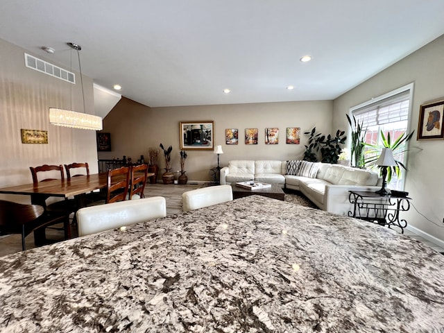 living area with visible vents, recessed lighting, and baseboards