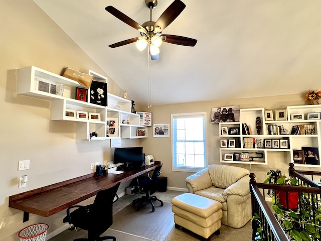 carpeted office featuring baseboards, ceiling fan, and vaulted ceiling