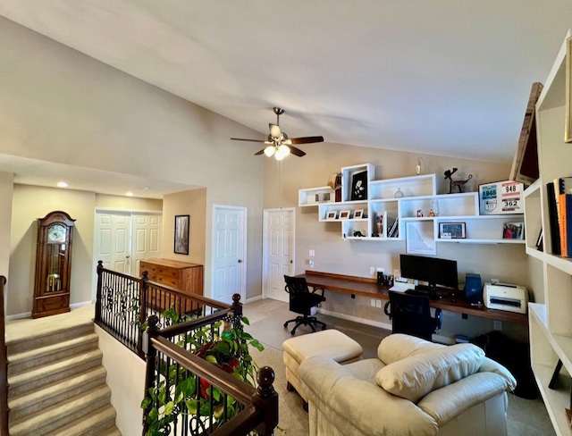 office space featuring built in desk, light colored carpet, high vaulted ceiling, and baseboards