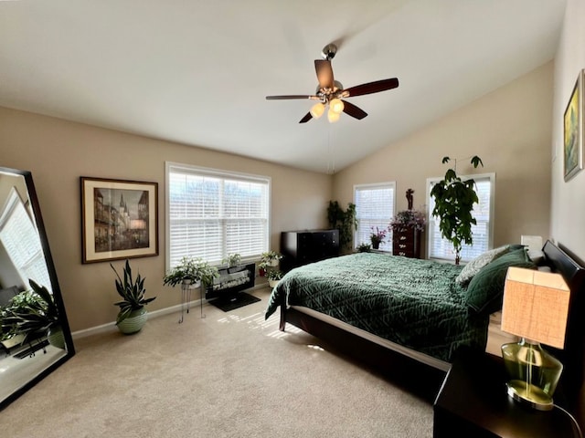 carpeted bedroom with baseboards, ceiling fan, and vaulted ceiling