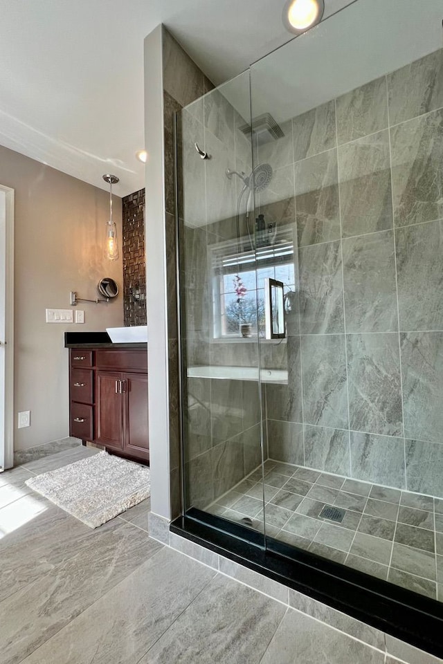 bathroom featuring a shower stall and vanity