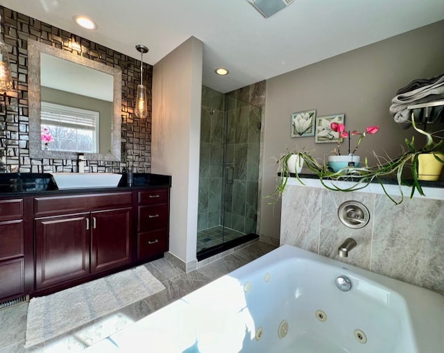 bathroom featuring vanity, a shower stall, a tub with jets, and visible vents